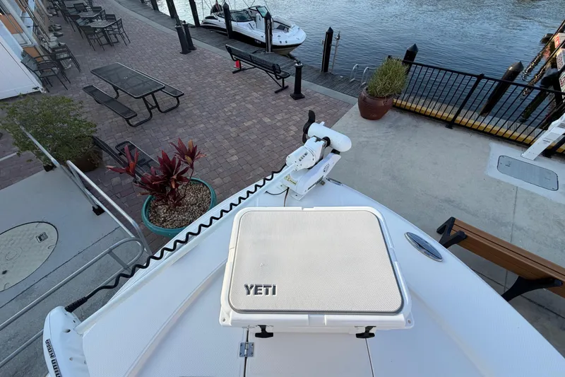 Slide: The Image of 2018 Robalo 246 Cayman boat docked by waterfront with Yeti cooler on deck. - 16