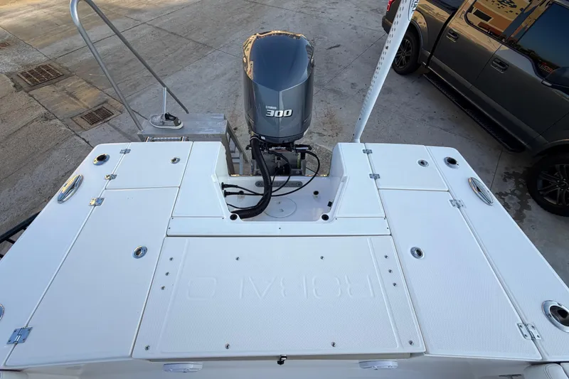 Slide: The Image of 2018 Robalo 246 Cayman boat with Yamaha 300 engine, docked on concrete surface. - 24