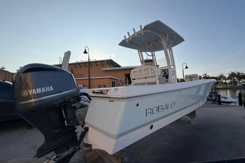 Slide: The Image of 2018 Robalo 246 Cayman boat with Yamaha engine, docked near waterfront building. - 5