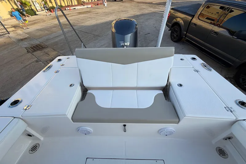 Slide: The Image of 2018 Robalo 246 Cayman boat interior with seating and storage compartments. - 25