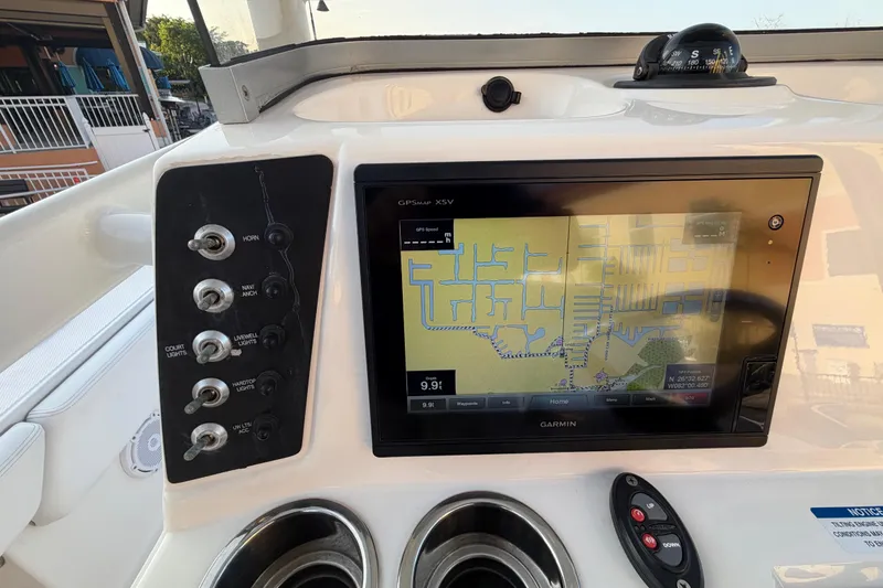 Slide: The Image of Dashboard of a 2018 Robalo 246 Cayman with Garmin GPS and control switches. - 29