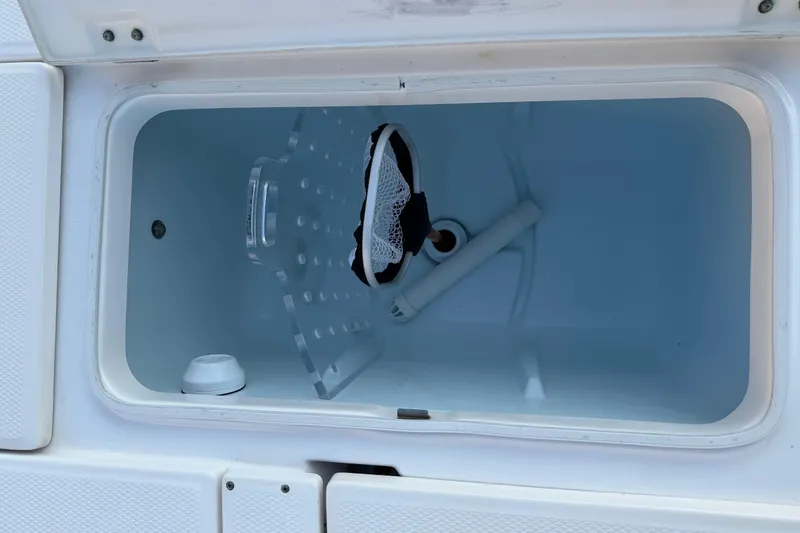 Slide: The Image of Open storage compartment on a 2018 Robalo 246 Cayman boat. - 27
