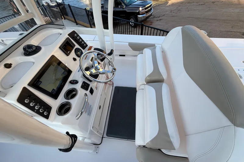 Slide: The Image of 2018 Robalo 246 Cayman boat cockpit with steering wheel and navigation system. - 8