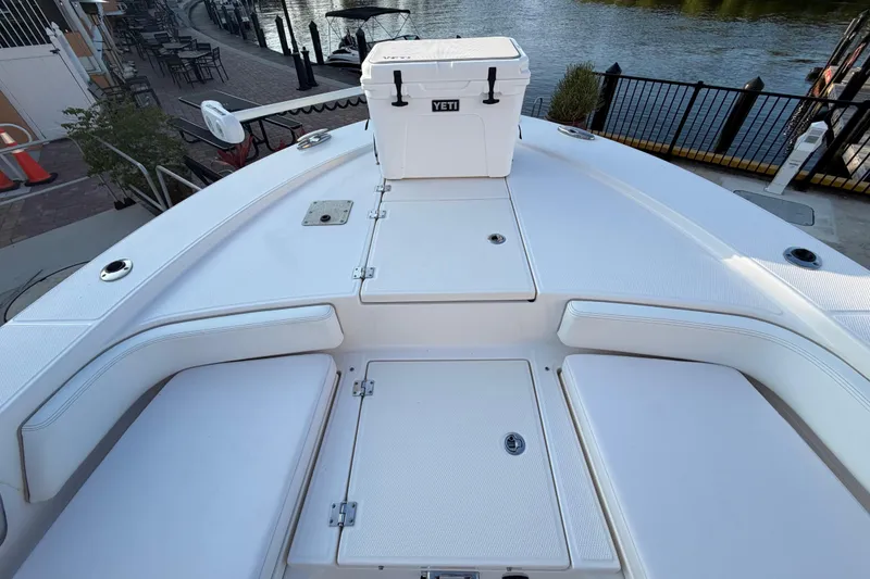 Slide: The Image of 2018 Robalo 246 Cayman boat deck with seating and Yeti cooler. - 13