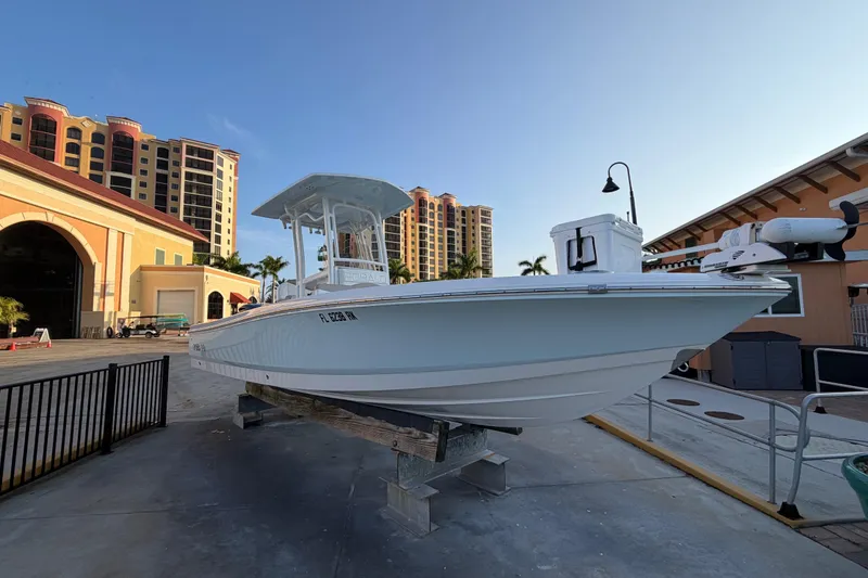 Slide: The Image of 2018 Robalo 246 Cayman boat displayed outdoors near modern buildings. - 4