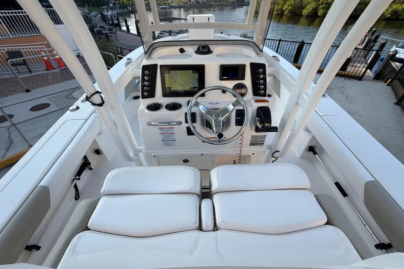 Slide: The Image of 2018 Robalo 246 Cayman boat cockpit with steering wheel and navigation displays. - 10