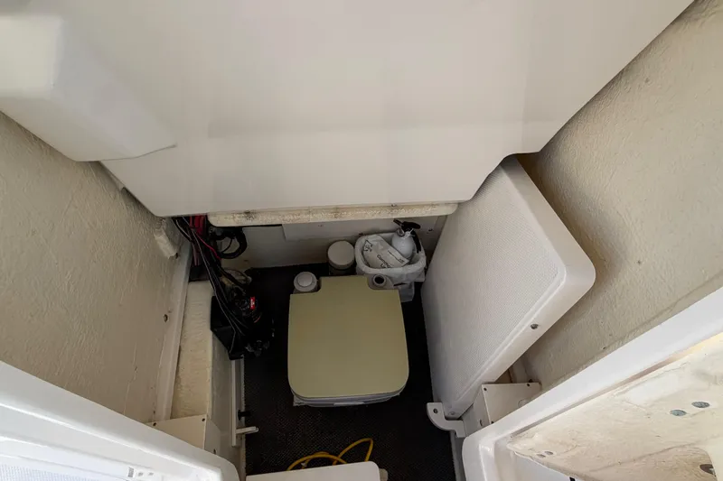 Slide: The Image of Interior view of 2018 Robalo 246 Cayman boat storage compartment with equipment. - 21