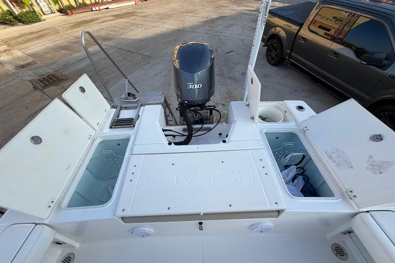 Slide: The Image of 2018 Robalo 246 Cayman boat with open storage compartments and Yamaha 300 engine. - 26