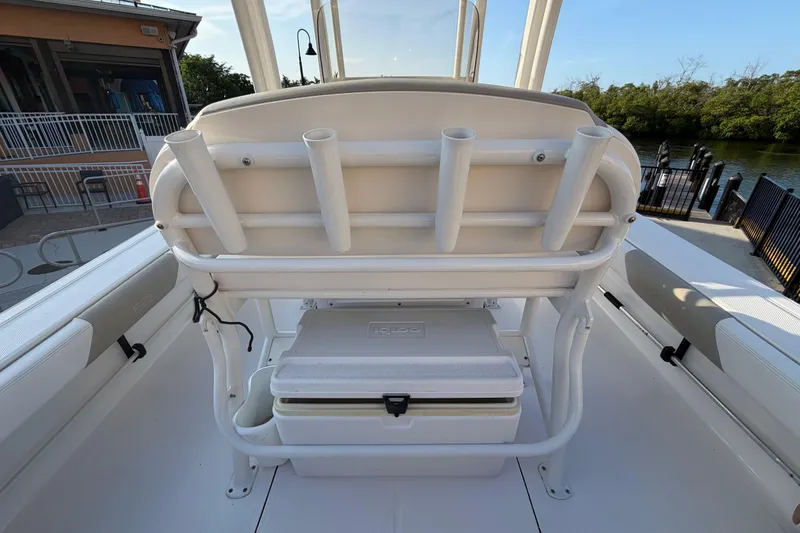 Slide: The Image of 2018 Robalo 246 Cayman boat interior with rod holders and cooler storage. - 23