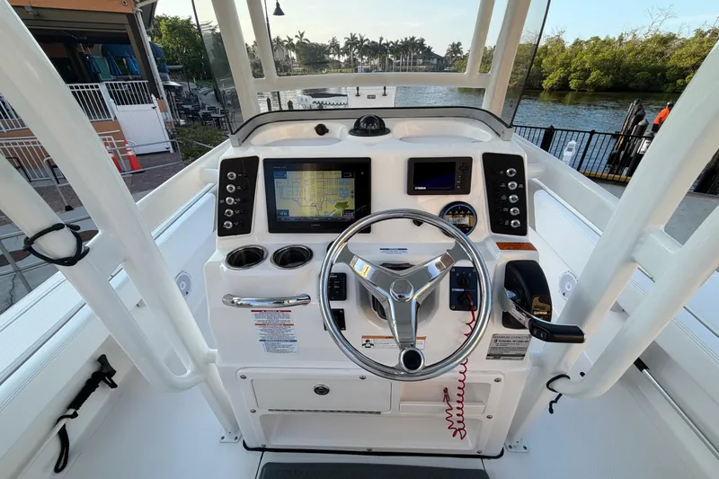 Slide: The Image of 2018 Robalo 246 Cayman boat dashboard with steering wheel and navigation system. - 7