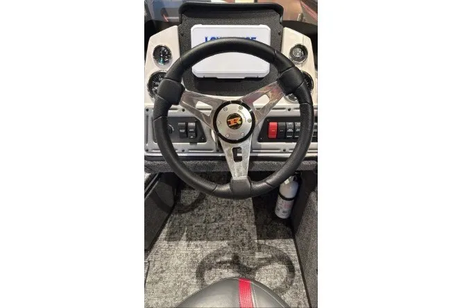 Slide: The Image of Steering wheel of 2026 Ranger VS1682SC Angler boat, featuring modern dashboard controls. - 2