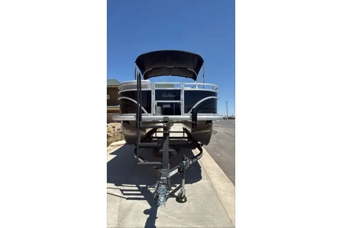 Slide: The Image of 2026 Sun Tracker SportFish 20 DLX pontoon boat on trailer, front view, sunny day. - 91
