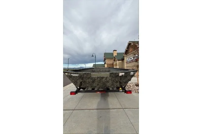 The Image of 2026 Tracker Grizzly 2072 Utility boat on trailer, parked outdoors. - 0