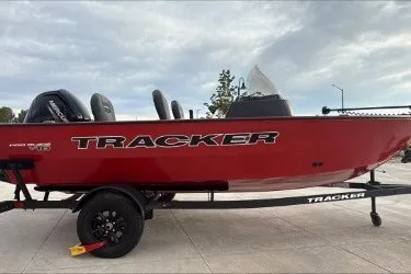 The Image of 2026 Tracker Pro Guide V-16 SC boat in vibrant red on a trailer. - 0