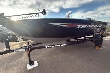 The Image of 2026 Tracker Pro Guide V-16 SC boat on trailer, parked outdoors. - 0