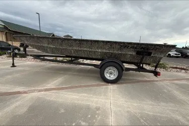 The Image of 2026 Tracker Grizzly 1754 Utility boat on trailer, parked outdoors. - 0