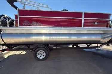 The Image of 2026 Sun Tracker Party Barge 18 DLX pontoon boat with red exterior on trailer. - 0