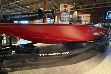 The Image of 2026 Tracker Savage 215 boat displayed indoors on a trailer. - 0