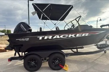 The Image of 2026 Tracker Pro Guide V-175 WT boat on trailer, black exterior, parked outdoors. - 0