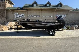 The Image of 2026 Ranger VS1782SC Angler boat displayed outdoors with dealership signage in the background. - 0