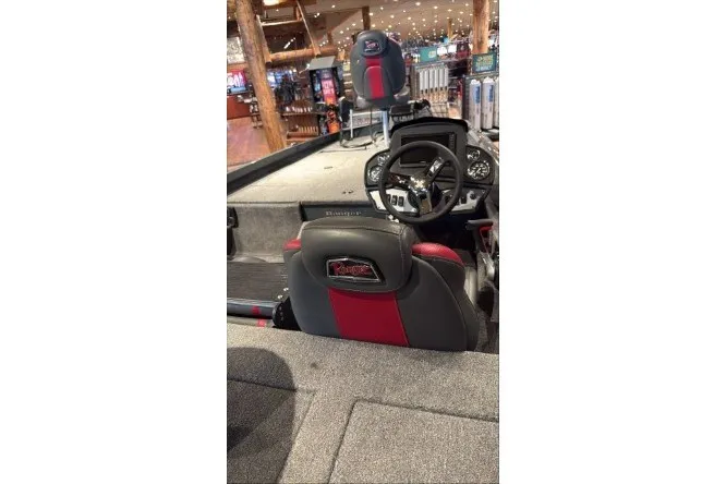 Slide: The Image of 2026 Ranger RT188P boat interior with steering wheel and seating in showroom. - 1