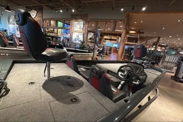 Slide: The Image of 2026 Ranger RT188P boat interior with seating and steering wheel in showroom setting. - 2