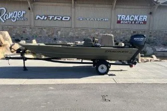 The Image of 2026 Tracker Grizzly 1648 SC boat on trailer outside dealership. - 0