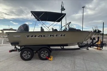 The Image of 2026 Tracker Targa V-19 WT boat on trailer, parked outdoors under cloudy sky. - 0