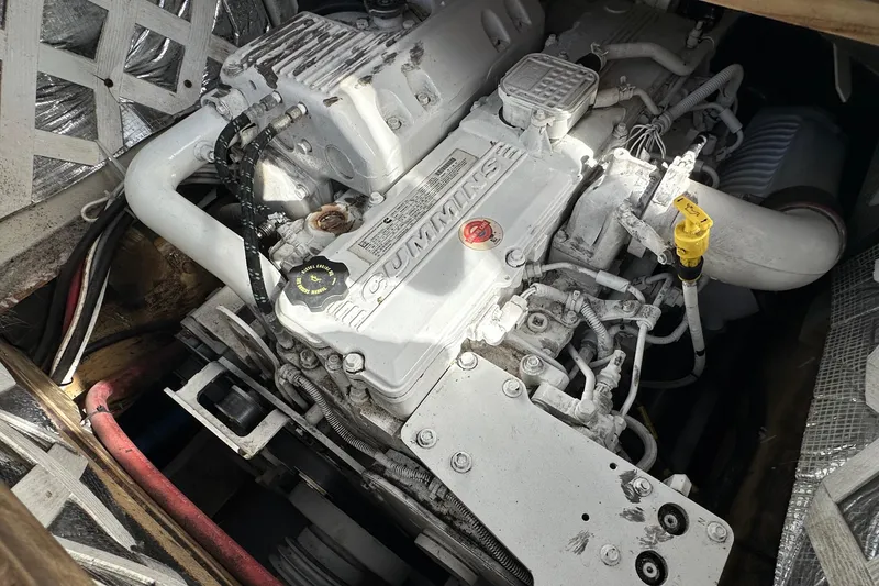 Slide: The Image of Engine compartment of a 2016 Libby Downeast boat, featuring a Cummins diesel engine. - 12