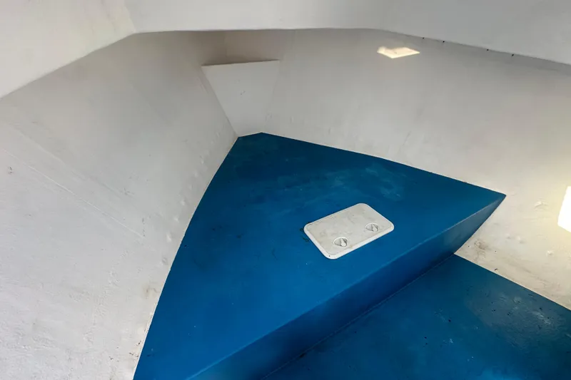 Slide: The Image of Interior of 2016 Libby Downeast boat with blue flooring and white hatch. - 20