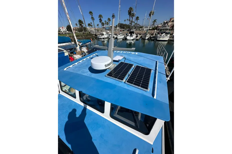 Slide: The Image of Blue 2016 Libby Downeast boat with solar panels docked in marina. - 25