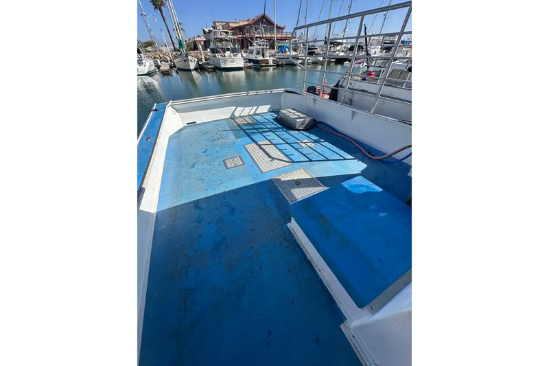 Slide: The Image of Open deck of a 2016 Libby Downeast boat in a marina setting. - 23