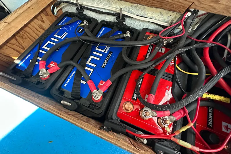 Slide: The Image of Deep cycle batteries with cables in a wooden compartment, Libby Downeast 2016 model. - 22