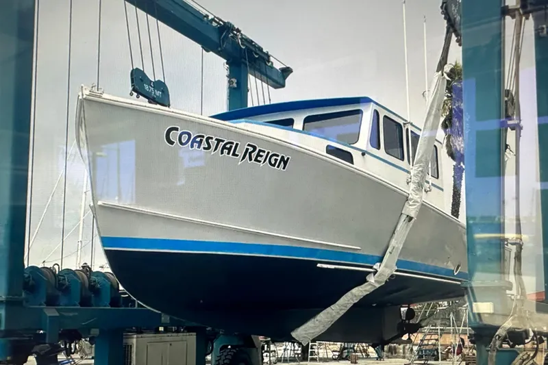 Slide: The Image of 2016 Libby Downeast boat "Coastal Reign" on lift at marina. - 8