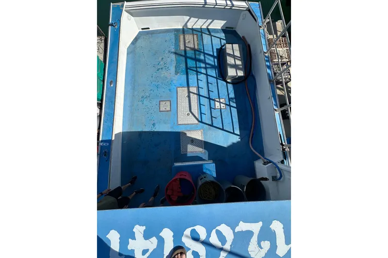 Slide: The Image of Overhead view of a 2016 Libby Downeast boat deck with equipment and shadows. - 28