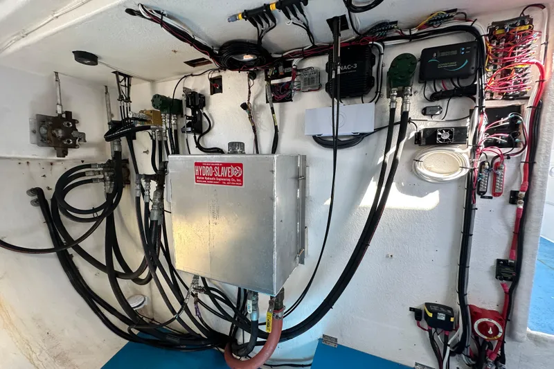 Slide: The Image of Hydraulic and electrical systems inside a 2016 Libby Downeast boat, featuring Hydro-Slave components. - 13