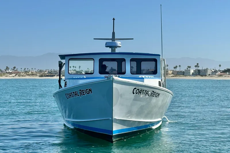 Slide: The Image of Front view of 2016 Libby Downeast boat "Coastal Reign" on calm water near shore. - 7