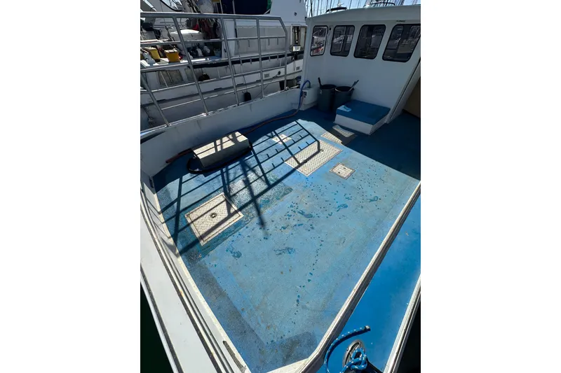 Slide: The Image of Spacious deck of 2016 Libby Downeast boat with blue flooring and railing. - 26