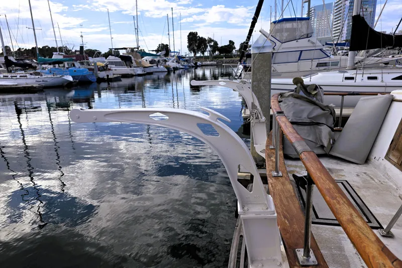Slide: The Image of 1978 CHB 34 trawler docked in a marina with calm waters and surrounding boats. - 36
