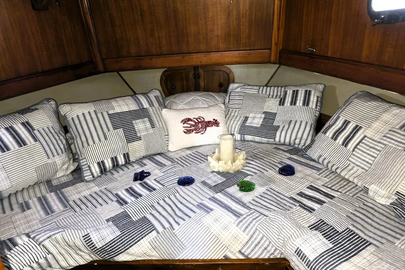 Slide: The Image of Cozy cabin interior of 1978 CHB 34 trawler with striped bedding and decorative pillows. - 13