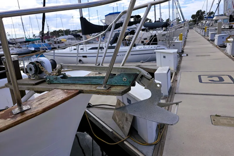 Slide: The Image of 1978 CHB 34 Trawler with anchor at marina dock, surrounded by other boats. - 4