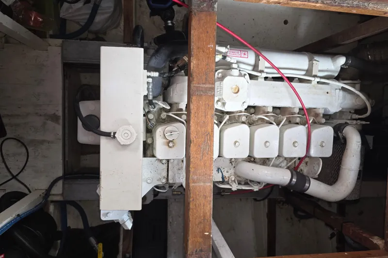 Slide: The Image of Engine compartment of a 1978 CHB 34 trawler, showcasing mechanical components and piping. - 38