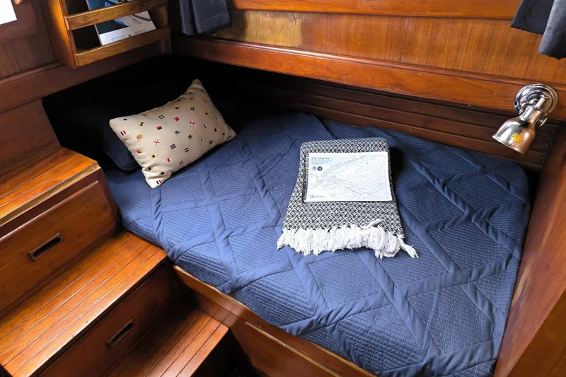 Slide: The Image of Cozy cabin interior of 1978 CHB 34 trawler with blue bedding and nautical decor. - 16