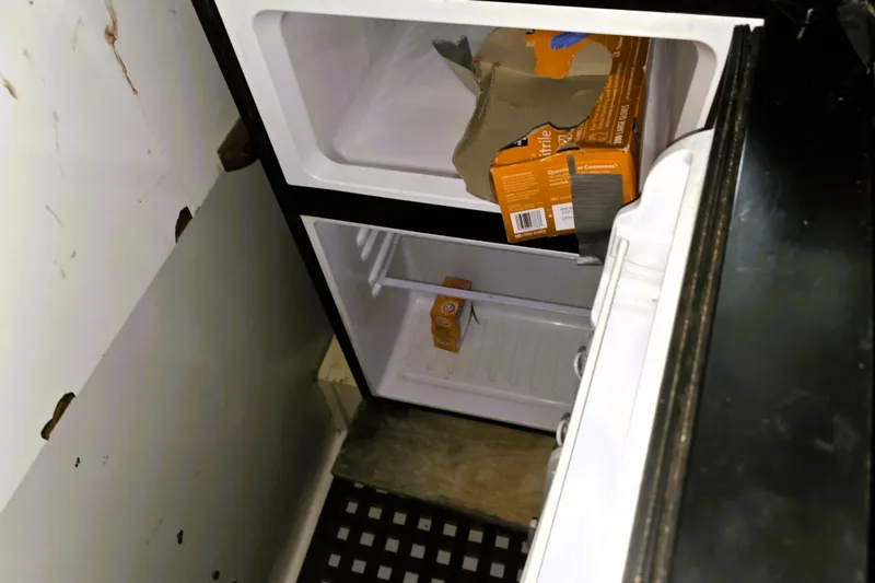 Slide: The Image of Small refrigerator with baking soda boxes inside, aboard a 1978 CHB 34 trawler. - 10