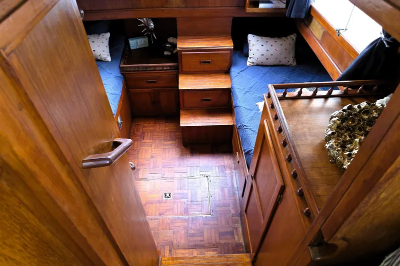 Slide: The Image of Cozy 1978 CHB 34 trawler cabin with wooden interior and twin beds. - 14