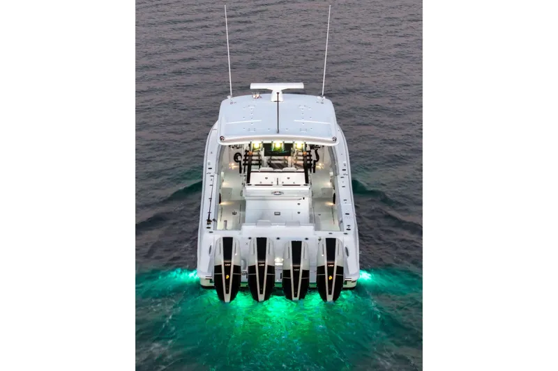 Slide: The Image of The 2026 HCB 42 Lujo features four outboard engines and glowing underwater lights. - 9