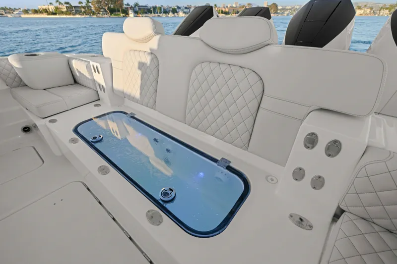 Slide: The Image of The image shows the luxurious cockpit of an HCB 42 Lujo boat with elegant, upholstered seating and a built-in aquarium. - 40