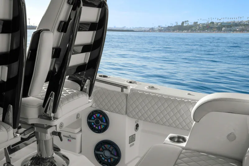 Slide: The Image of The 2026 HCB 42 Lujo features luxurious seating and speakers, overlooking the ocean. - 31