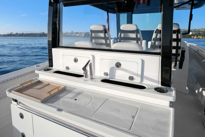 Slide: The Image of The image shows the cockpit of a 2026 HCB 42 Lujo with sleek white seats and a sink. - 26
