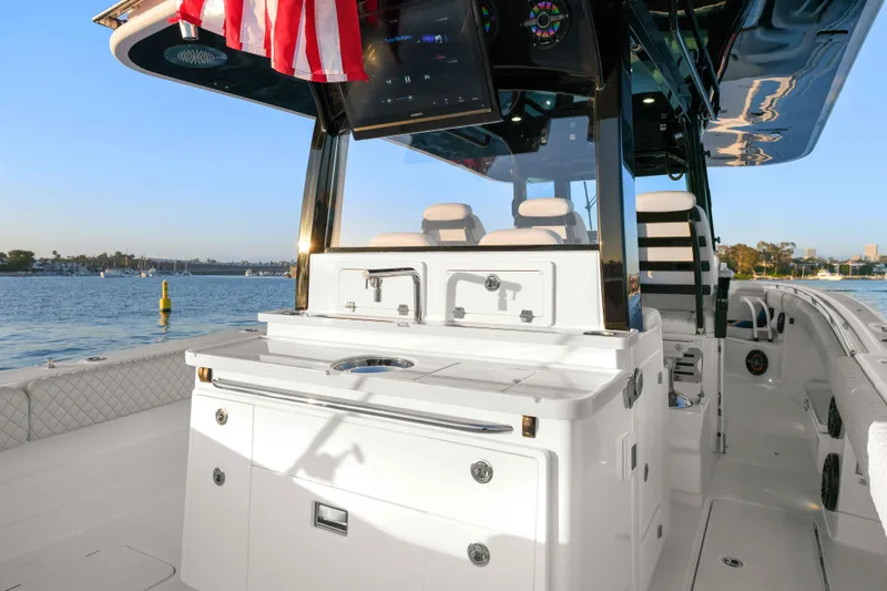 Slide: The Image of The image shows the cockpit of an HCB 42 Lujo boat with modern features and an American flag. - 46